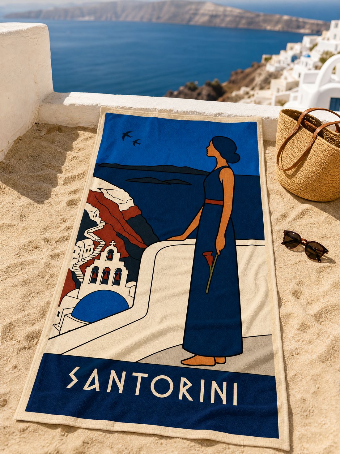 The SANTORINI beach towel spread on the sand