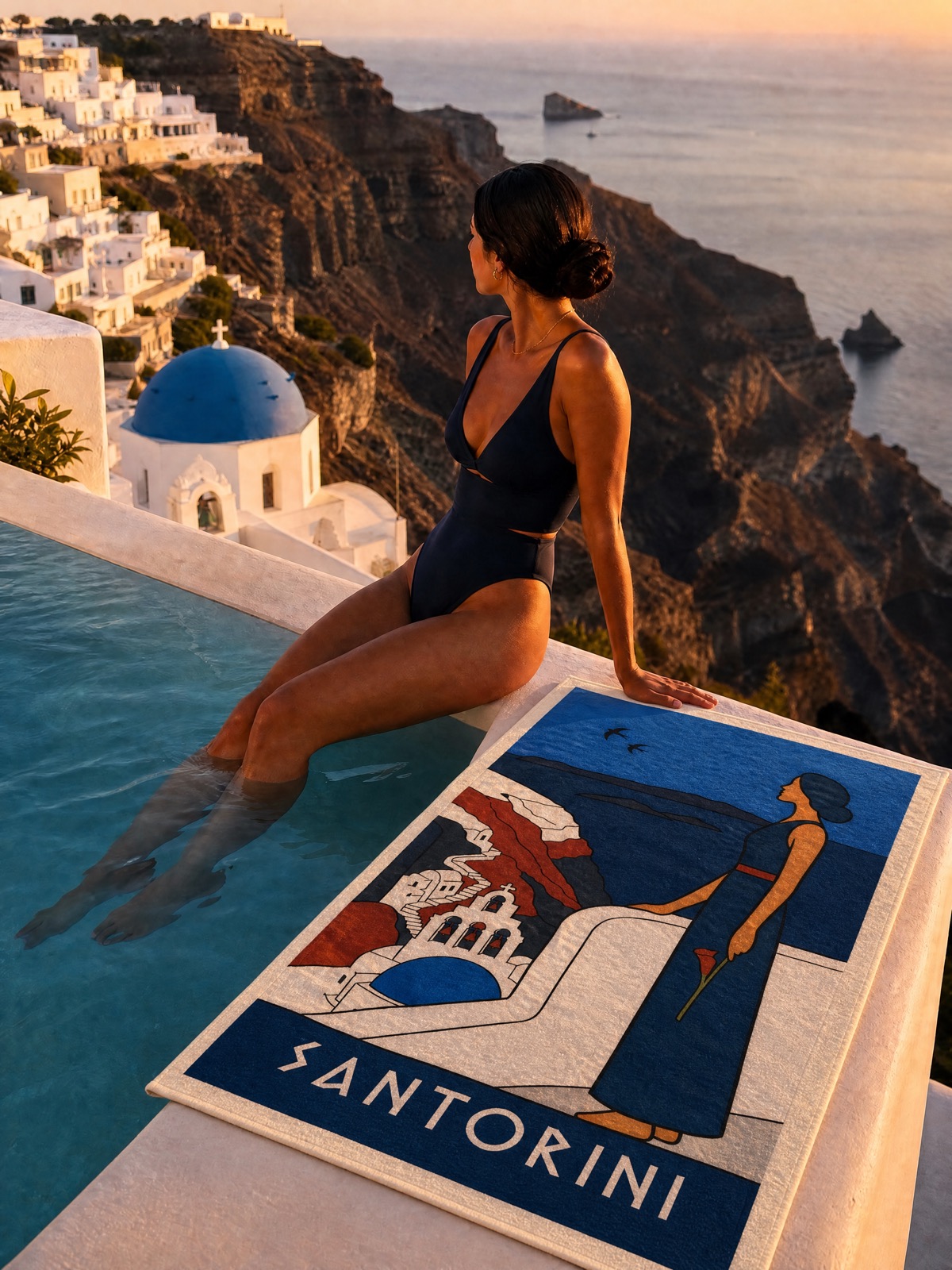 The SANTORINI beach towel at the caldera pool at dusk